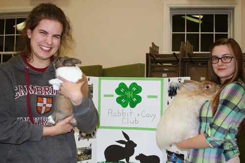 Megan Kaiser with Wilbur and Olimpia Sienkiewicz with Beiber were signing up new members for the rabbit/cavy club. “Dairy outranks everybody but we do OK,” said Kaiser. Photo/Craig Bakay